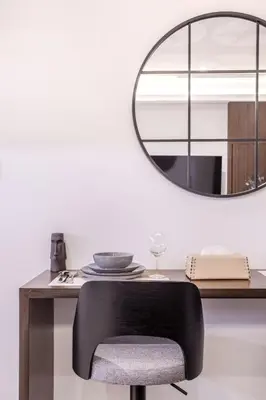 a black chair sitting in front of a table with a mirror at Stylish Studio Walk to Dubai Mall & Burj Khalifa in Dubai