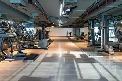 a gym with several treadmills and machines in it at Stylish Studio Walk to Dubai Mall & Burj Khalifa in Dubai