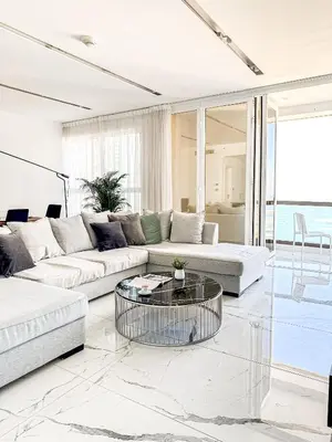 a living room with two couches and a glass table at GMA Murjan 2BR Sea View High Floor in Dubai