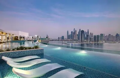 a hotel swimming pool with a view of the city at Fully-equipped studio Palm Jumeirah, Seven in Dubai