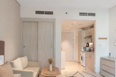 a living room with a couch and a table at Fully-equipped studio Palm Jumeirah, Seven in Dubai