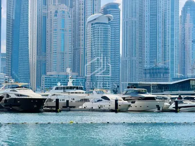 a group of boats docked in a harbor in a city at Marina Vista 1BD with beach access in Beachfront in Dubai
