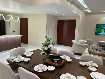 a living room with a table and a couch at USMANS 4BDRM APARTMENT SEA VIEW Direct BEACH Access Fully Serviced JBR in Dubai