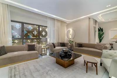 a living room with two couches and a table at USMANS 4BDRM APARTMENT SEA VIEW Direct BEACH Access Fully Serviced JBR in Dubai