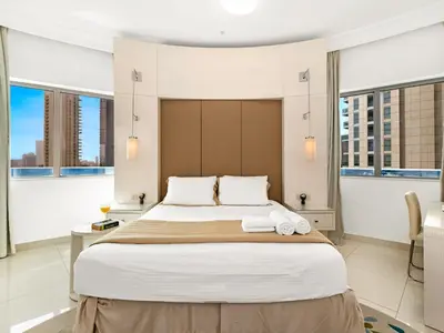 a bedroom with a large bed with two towels on it at Luxury 1br Burj Khalifa View in Dubai
