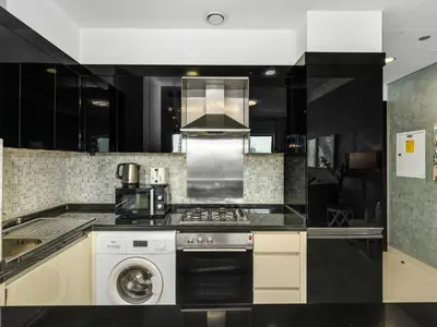 a kitchen with a stove and a washing machine at Luxury 1br Burj Khalifa View in Dubai