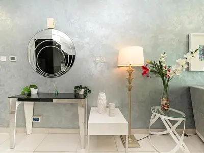 a room with a mirror and a table and a lamp at Luxury 1br Burj Khalifa View in Dubai