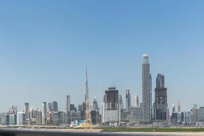 a view of a city skyline with skyscrapers at ON OFF HH-Meydan One- Cozy STUDIO - Burj Khalifa & Lagoon view in Dubai