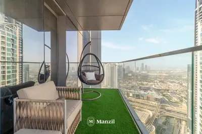 a balcony in a skyscraper with a swing at Manzil - 3BR in Boulevard Point connected to Dubai Mall with Incredible View of Burj Khalifa in Dubai