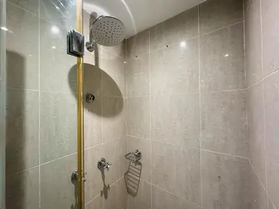 a bathroom with a shower with a glass door at Golden Homes Souk Al Bahar Burj khalifa view Tajer residences 1BR Mint avenue Near , Dubai mall & burj khalifa in Dubai