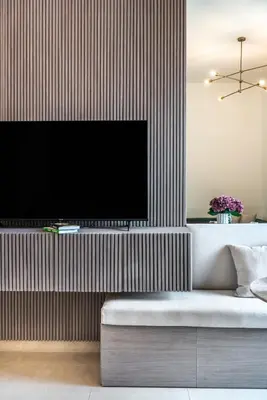 a living room with a tv on a wall at The Smart Concierge - Binghatti Canal in Dubai