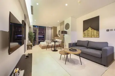 a living room with a couch and a table at Voguish studio! Walk to Burj Khalifasleeps 3! in Dubai