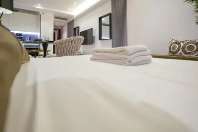 a pile of white towels sitting on top of a bed at Voguish studio! Walk to Burj Khalifasleeps 3! in Dubai
