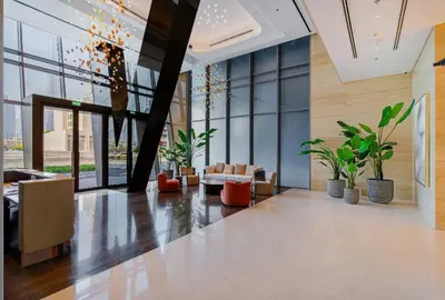 a lobby with potted plants in a building at Voguish studio! Walk to Burj Khalifasleeps 3! in Dubai