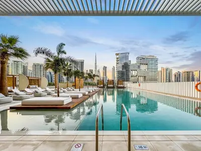 a swimming pool with a city skyline in the background at FAM Living - Upside Living - WFH Friendly-Business Bay in Dubai