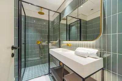 a bathroom with a sink and a shower with a mirror at FAM Living - Upside Living - WFH Friendly-Business Bay in Dubai