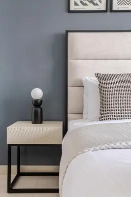 a bedroom with a bed and a nightstand next to a bed at Frank Porter - Ocean Heights in Dubai