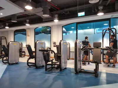 a gym with a bunch of chairs and people in it at GuestReady - Beachside Escape near Marina Beach in Dubai