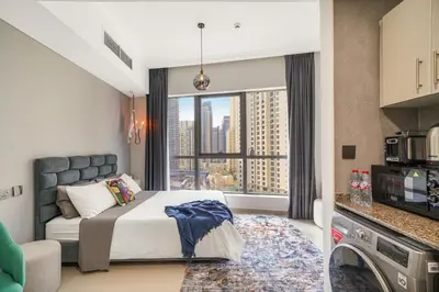 a bedroom with a bed and a large window at Iolanda Home in Dubai