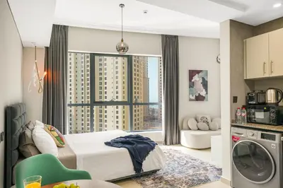 a bedroom with a bed and a large window at Iolanda Home in Dubai
