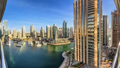 a view of a city with boats in the water at Stunning 1BD Marina view apartment in Dubai Marina in Dubai