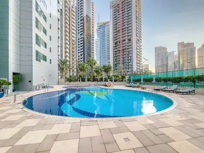 a swimming pool in the middle of a building with tall buildings at Stunning 1BD Marina view apartment in Dubai Marina in Dubai