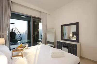 a bedroom with a large white bed and a mirror at Luxury 3B and maids Burj View, Steps to Dubai Mall in Dubai