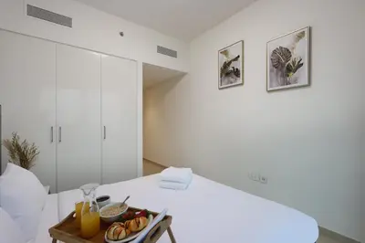a white room with a tray of food on a table at Luxury 3B and maids Burj View, Steps to Dubai Mall in Dubai