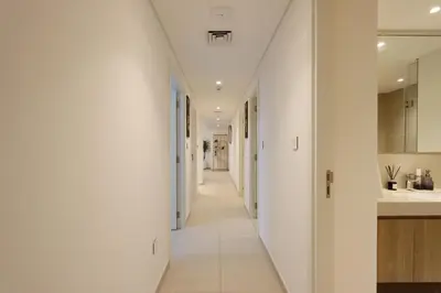 a hallway of a house with white walls at Luxury 3B and maids Burj View, Steps to Dubai Mall in Dubai