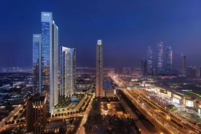 a city skyline with tall buildings at night at Luxury 3B and maids Burj View, Steps to Dubai Mall in Dubai