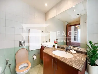 a bathroom with a toilet and a sink at 1 Bedroom Apartment in JLT in Dubai