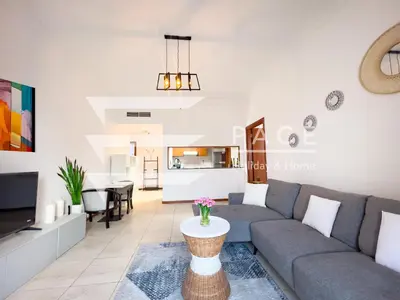 a living room with a couch and a table at 1 Bedroom Apartment in JLT in Dubai