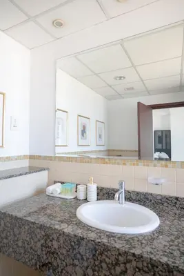a bathroom with a sink and a large mirror at GMA Amwaj 2BR Sea View High Floor in Dubai