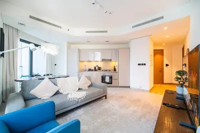 a living room with a couch and a table at SettlerHomes - 2BR Downtown Haven, Ideal For Family Comfort in Dubai
