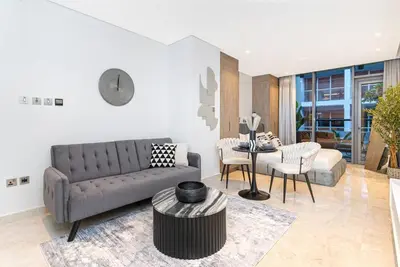 a living room with a couch and a table at Trendy Studio! Walk to Burj Khalifasleeps 3! in Dubai