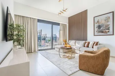 a living room with a couch and a table at Frank Porter - Act One Act Two T1 in Dubai