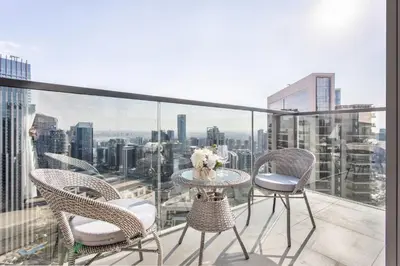 a balcony with chairs and a table with a view at Frank Porter - Act One Act Two T1 in Dubai