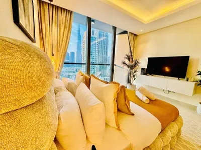 a bedroom with a large bed with a large window at Chic Studio with Burj Views at Sterling by Omniyat in Dubai