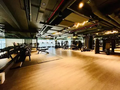 a gym with several treadmills and chairs in a room at Chic Studio with Burj Views at Sterling by Omniyat in Dubai