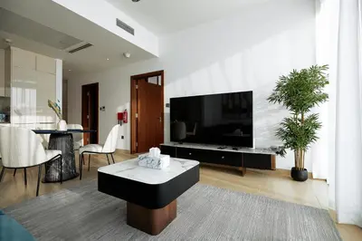a living room with a large flat screen tv at BRAND NEW LUXURY 1 BR Apartment at Marina Gate 2 full Marina view in Dubai