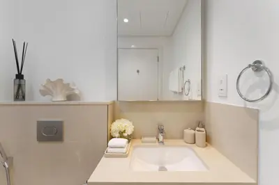 a bathroom with a large sink and a mirror at Daniels 2BR at Downtown with Burj Khalifa View in Dubai