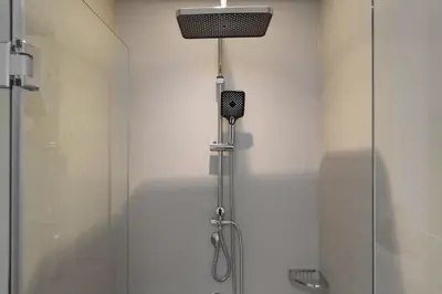 a bathroom with a shower with a glass door at Daniels 2BR at Downtown with Burj Khalifa View in Dubai