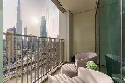 a balcony with chairs and a view of a city at Daniels 2BR at Downtown with Burj Khalifa View in Dubai