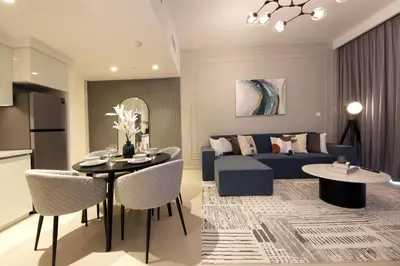 a living room and a bedroom with a bed and a table at RH- Live in Luxury, 01BR with spectacular view in Dubai