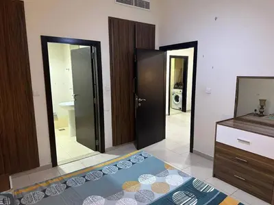 a bathroom with two sliding doors and a mirror at Stylish 1bhk at silicon oasis in Dubai