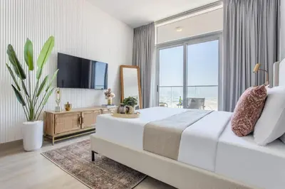 a bedroom with a large bed and a large window at Frank Porter - Bloom Tower C in Dubai
