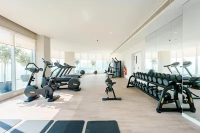 a gym with treadmills and machines in a room at Stayis -Luxurious 2BR Apartment with breathtaking ocean and Marina View in Dubai