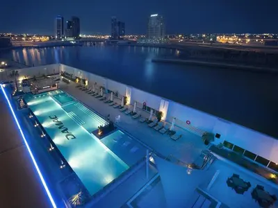 a swimming pool on top of a cruise ship at night at Luxury Hotel Apartment - DownTown in Dubai
