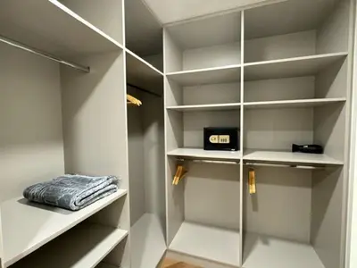 a walk in closet with white shelves and a box at Oraya - Brand New Luxurious 3BR plus 2M Villa in Maple 2 in Dubai