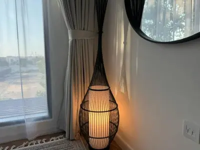 a lamp in a corner of a room next to a window at Oraya - Brand New Luxurious 3BR plus 2M Villa in Maple 2 in Dubai